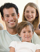 group photo of a smiling man and his two children